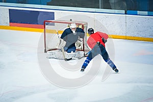 Professional ice hockey player on the ice hockey stadium train together with goalie. Sport photo, edit space, winter game Pyeongch