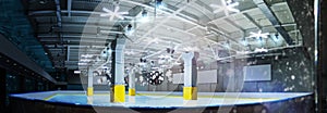 Professional ice skating rink. Beautiful empty winter background and empty ice rink with lights.Wide angle