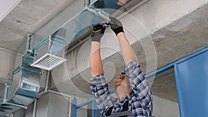 Professional Indian Heating and Cooling Technician Worker Finishing Newly Assembled Air Vent Shaft. Air Climate Control