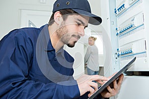 Professional industrial engineer adjusting modern machine settings