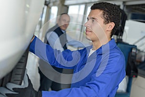 Professional industrial engineer adjusting modern machine settings