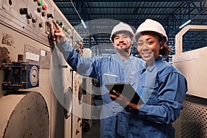 Professional industry engineers partner looking at camera and smile in factory