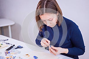 Designer making handmade eardrop photo