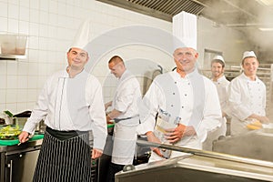 Professional kitchen busy team cooks and chef