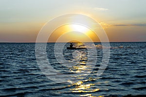 Professional kiter doing a complicated trick on a beautiful sunset background