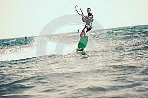 Professional kiter makes the difficult trick on a beautiful background