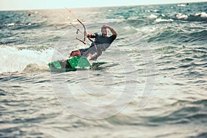 Professional kiter makes the difficult trick on a beautiful background