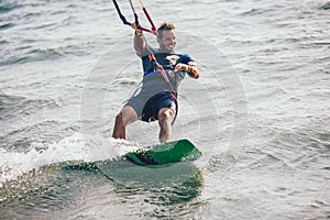 Professional kiter makes the difficult trick on a beautiful background