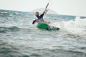 Professional kiter makes the difficult trick on a beautiful background.