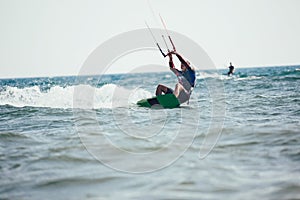 Professional kiter makes the difficult trick on a beautiful background.