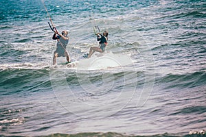 Professional kiter makes the difficult trick on a beautiful background