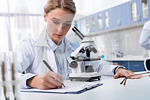 Lab technician taking notes