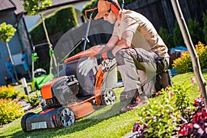 Professional Landscape Gardener Getting Ready to Mow the Lawn