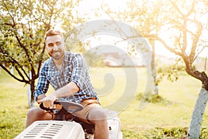 Professional landscaper using tractor at mowing lawn