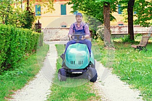 Professional lawn mower worker cutting grass in home garden