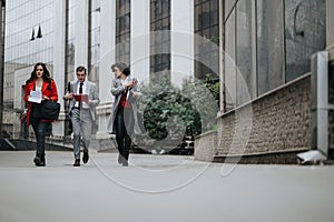 Professional lawyers walking outdoors for a business meeting