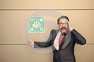 Professional leader extremely pointing to meeting point sign. Manager in suit crying with hands about place for meeting. Best