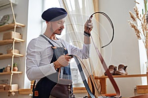 professional leather things craftsman at work in a vintage workshop