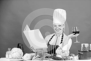 Professional level. Woman hat and apron study culinary arts. Culinary expert. Chef cooking healthy food. Girl read book