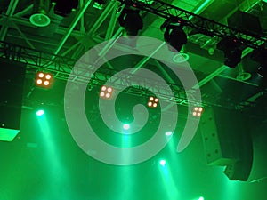 Professional lighting equipment on the ceiling of the stage on a green background