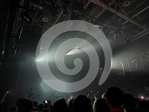 Professional lighting equipment on stage ceiling on blurred smoke background. View from below