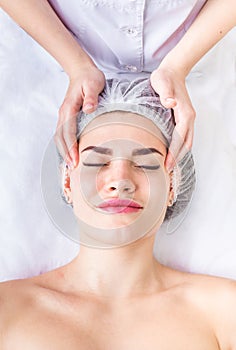 Professional lymphodrainage facial massage The cosmetologist is touching the client`s forehead. Lifting Skin care
