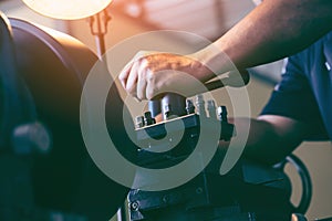 Professional machinist : man operating lathe grinding machine