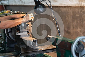 Professional machinist : man operating lathe grinding machine - metalworking industry concept. Mechanical Engineering control lath