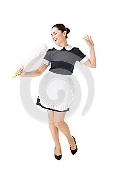 Professional maid in uniform having fun and singing in duster