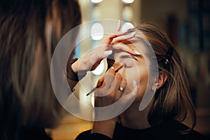 Professional Make-up Artist Applying Eyeshadow with a Brush