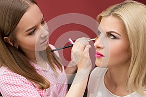 Professional Make-up artist doing glamour model