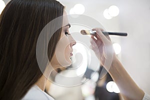 Professional make up artist doing make up in beauty salon