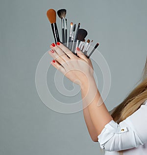 Professional make-up brush cosmetic in female hand beautician