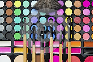 Professional make up brushes on eyeshadow palette