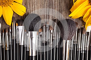 Professional Make up brushes next to beautiful wild flowers