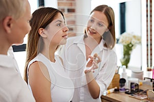 Professional make-up stylists paint model`s face