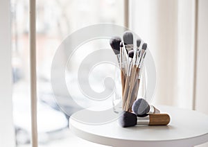 Professional makeup brushes in a glass