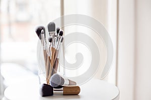 Professional makeup brushes in a glass