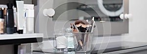 Professional makeup brushes set closeup near salon mirror. Brush any size for professional make-up artist on blur