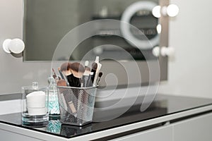 Professional makeup brushes set closeup near salon mirror. Brush any size for professional make-up artist on blur