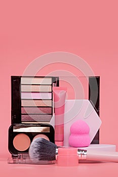 Professional makeup tools. Products for makeup on pink background. A set of various products for makeup