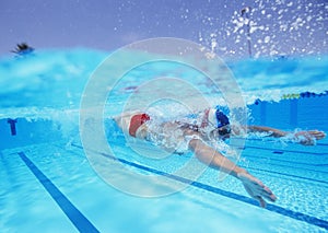 Professional male athlete swimming in pool