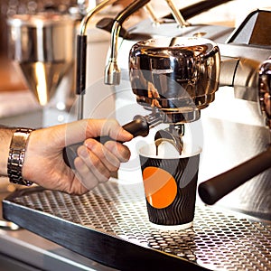 Professional male barista making coffee