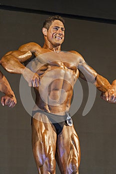 Professional Male Caucasian Bodybuilder Performing on Stage.