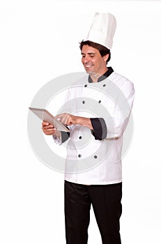 Professional male chef working on tablet pc