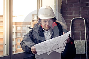 Professional male construction businessman with his blueprints. Soft focus, toned.