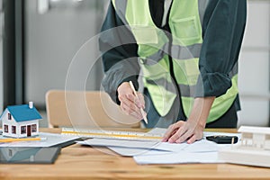 Professional male Construction Engineer Reviewing Blueprints on Worksite. photo