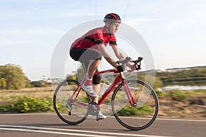 Professional Male Cyclist in Racing Outfit During a Ride on Bike Outdoors