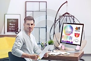 Professional male designer working at desk in office