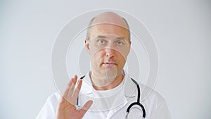 Professional male doctor explaining diagnosis and calming patient